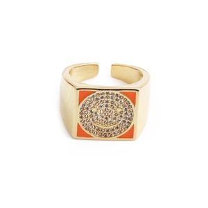 Macro detail of golden square ring with zircon smiley face and orange enamel accents