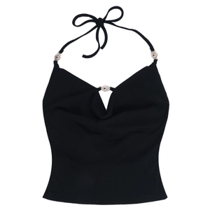 Detail of black halter crop top with three silver sun-shaped metal ornaments on neckline
