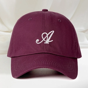 Classic burgundy cotton baseball cap with white embroidered letter A on a satin backdrop