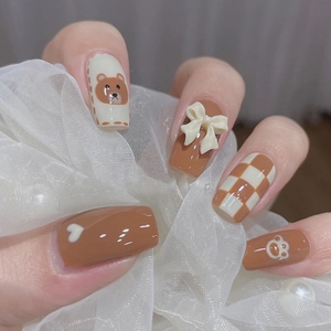 Cute brown cartoon bear and checkerboard press-on nails with bow and heart accents