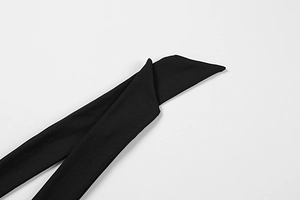 Close-up of the black dress straps with precise diagonal cut and high-quality fabric texture