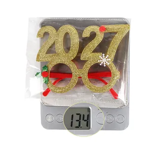 Detail shot of 2027 Christmas glasses showing 13.4g weight on a digital scale