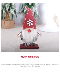 Detail of wooden Christmas gnome ornament with red snowflake hat on a festive tabletop