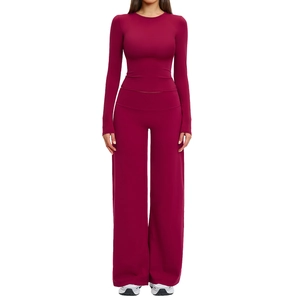 Women's burgundy yoga set with long sleeve crop top and high waisted wide leg trousers