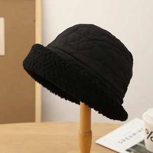Chapeau bob d'hiver noir matelassé avec bord en polaire sur un support en bois élégant