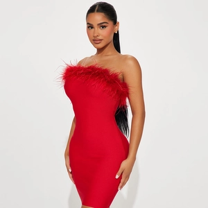 Sultry red strapless bodycon mini dress with luxury feather trim on white background