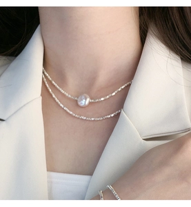 Close-up of a double-layered S925 silver beaded necklace with a baroque pearl pendant