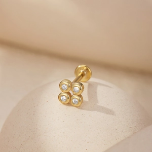 Close-up of gold-plated S925 sterling silver four-leaf clover stud earring with 925 hallmark