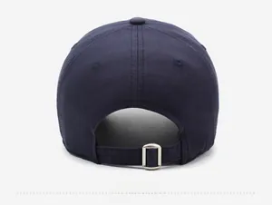 Close-up of dark blue cotton baseball cap featuring an adjustable metal buckle strap