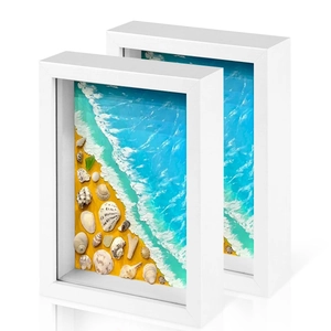 Set of 2 3D ocean shadow box frames with white borders featuring beach sand and shells