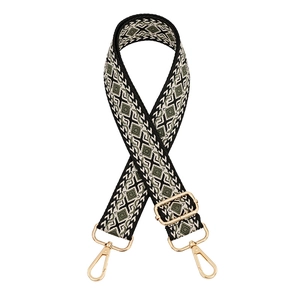 Detail of ethnic geometric woven strap in black and olive with gold metal hooks