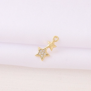 Golden double star pendant with clear cubic zirconia inlays and metal connection loop