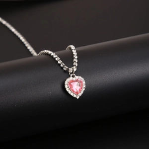 Close-up of pink heart zircon pendant with micro-pave crystals on silver tennis chain