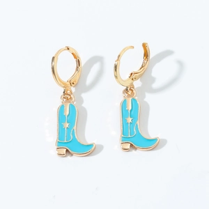 Detail of gold-tone western cowboy boot earrings with blue enamel and star accents