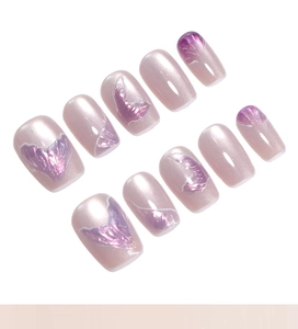 Detail of pink cat-eye press-on nails with iridescent mermaid tail texture and pearl finish