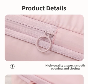 Detail of pink travel bag showing smooth resin zipper with circular ring pull