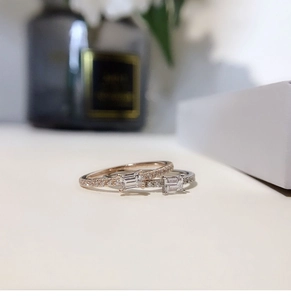 Detail of square emerald-cut cubic zirconia rings in rose gold and silver finishes