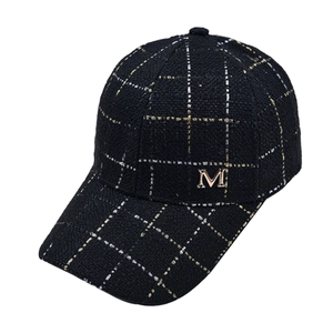 Classic black tweed plaid baseball cap with gold metallic M logo and curved brim design