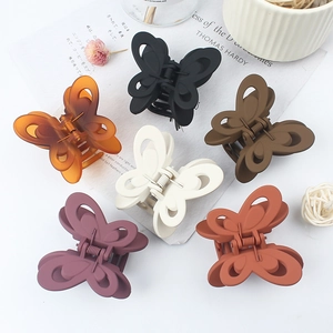 Elegant butterfly hair claws in six matte colors including black, amber, and purple