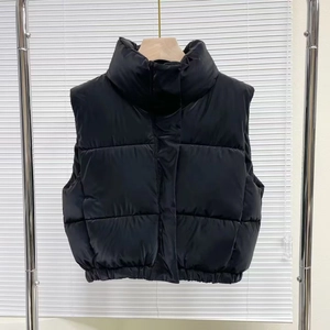 Women's minimalist black padded vest with a stand collar and high-gloss quilted finish