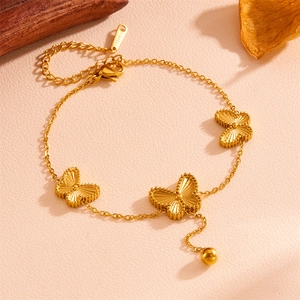 Detail of gold stainless steel butterfly necklace showing S-STEEL engraved charm
