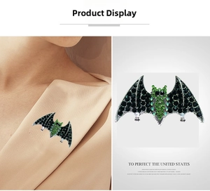 Macro detail of gothic bat brooch with black rhinestones and vibrant green crystals