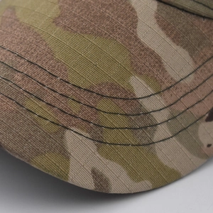 Close-up of four parallel stitching lines on camouflage baseball cap brim detail