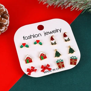 Close-up of 6 pairs of Christmas stud earrings featuring tree, gingerbread and gnome designs