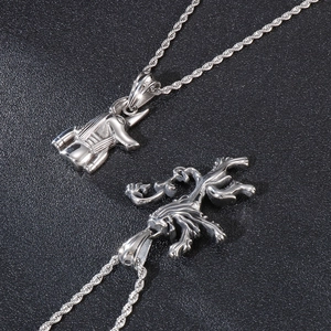 Detailed macro view of silver pyramid unicorn and lion head steel pendants on rope chains