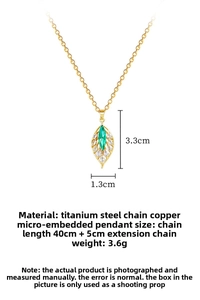 Macro view of gold titanium leaf pendant with green marquise stone and zircon pavé details