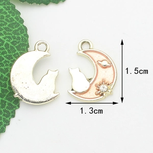 Macro detail of moon and cat charms showing 1.5cm x 1.3cm size and pink oil drip finish