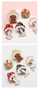 Detail of creative mushroom lady enamel pins with gold metal edges and vibrant colors