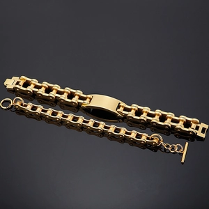 Polished gold motorcycle chain necklace and bracelet set for men on black mirror surface