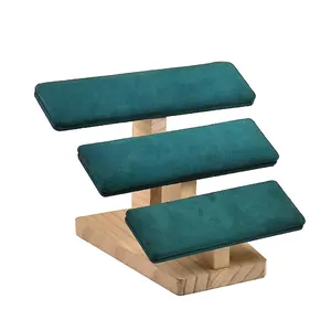 Three-tier solid wood jewelry display stand with dark green velvet tiers for watches and bracelets