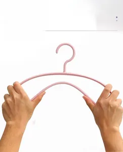 Close-up showing the high flexibility and anti-break durability of the pink plastic hanger
