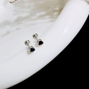 Detailed close-up of heart-shaped black zircon stud earrings with screw ball backings