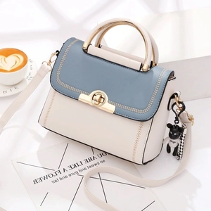 Fashionable two-tone PU leather handbag in beige and blue with cute bear pendant