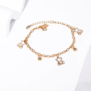 Detail of a golden bear bracelet with rhinestone charms and 750 hallmark engraving