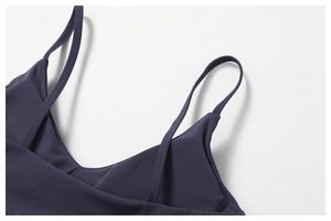 Detail of cross-back straps and premium matte fabric on a purple yoga sports bra