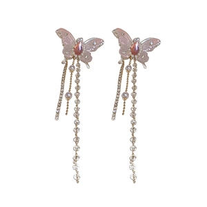Pink butterfly tassel earrings with cubic zirconia and pearls on white background