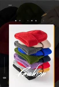 Detailed stack of various colorful knitted brimless beanies in autumn and winter shades