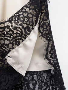Detail of black eyelash lace trim and silk satin fabric on this camisole top