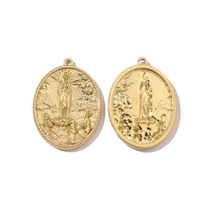 Detailed macro of golden oval religious pendants featuring Mary and cross relief