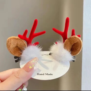 Handmade Christmas reindeer antler hair clips with plush ears and white pom-poms