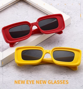 Close-up of stylish rectangle thick frame sunglasses in bold red and yellow colors