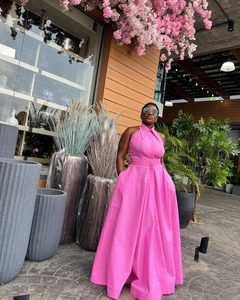 Detail of high waist sleeveless fuchsia maxi dress with front buttons and halter neckline