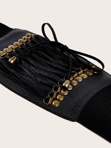 Detail of black corset belt with faux leather texture, bronze eyelets, and lace-up ties