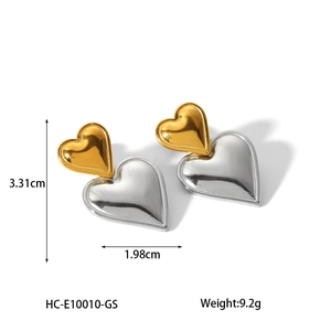 Macro view of heart-shaped two-tone 18K gold earrings with precise dimensions