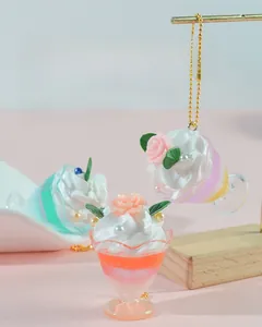Macro detail of simulated cream sundae keychain with resin roses and white pearls
