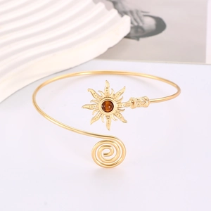 Detail of vintage sun arm cuff with turquoise stone on elegant white decorative stand